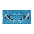 Towel/blanket with orca whale design on a blue abstract background