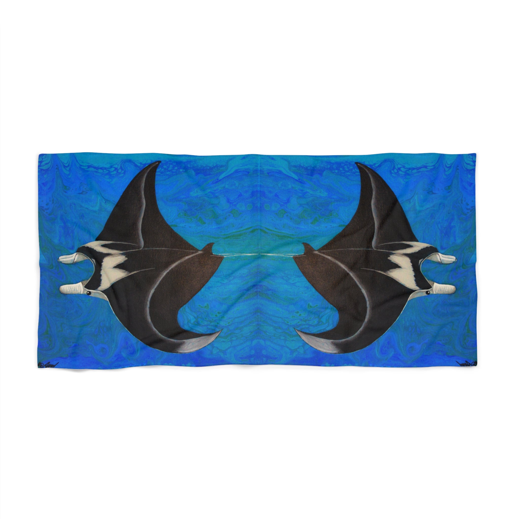Beach towel/blanket with manta ray design on a blue background