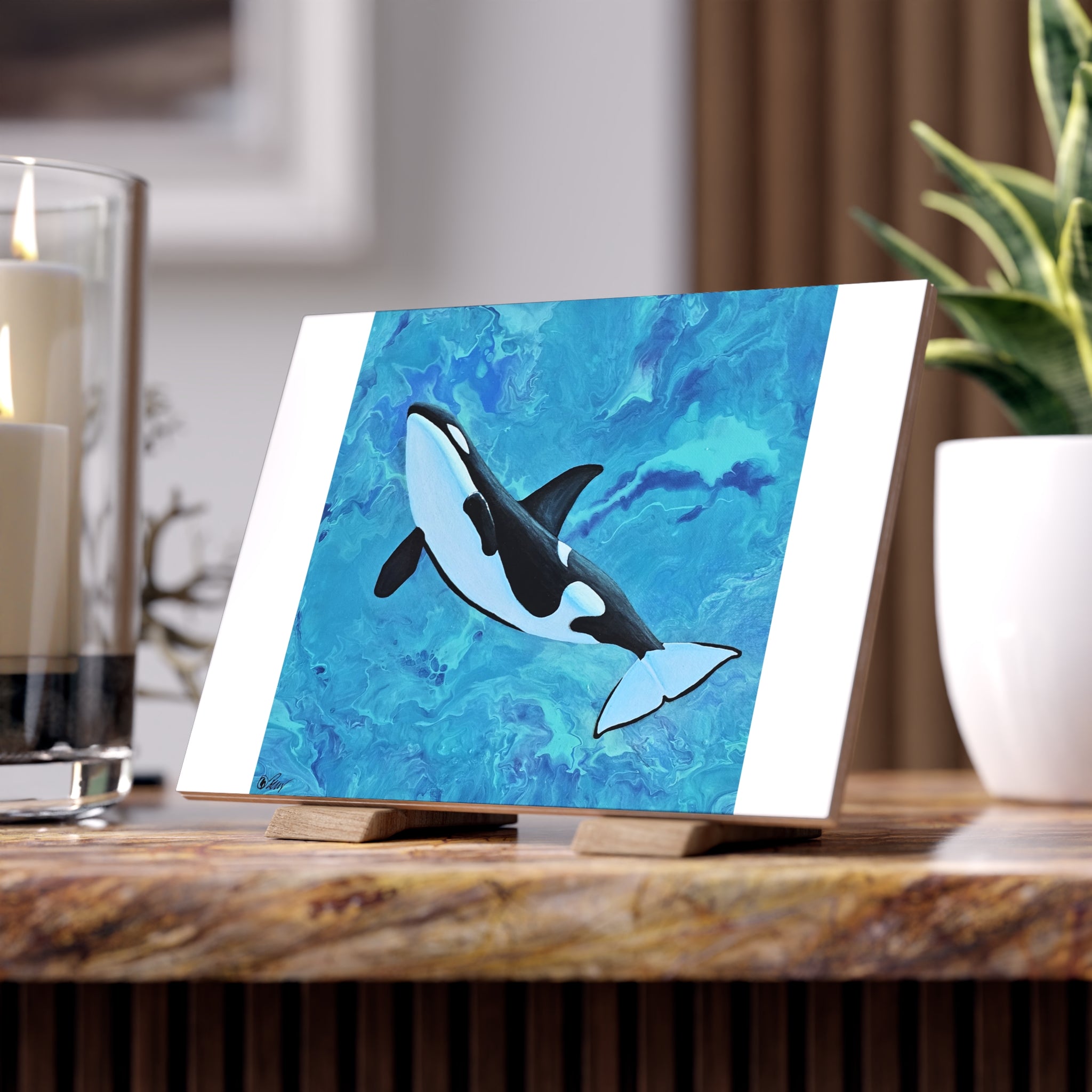 Orca whale painting on a stand with a blurred background tile