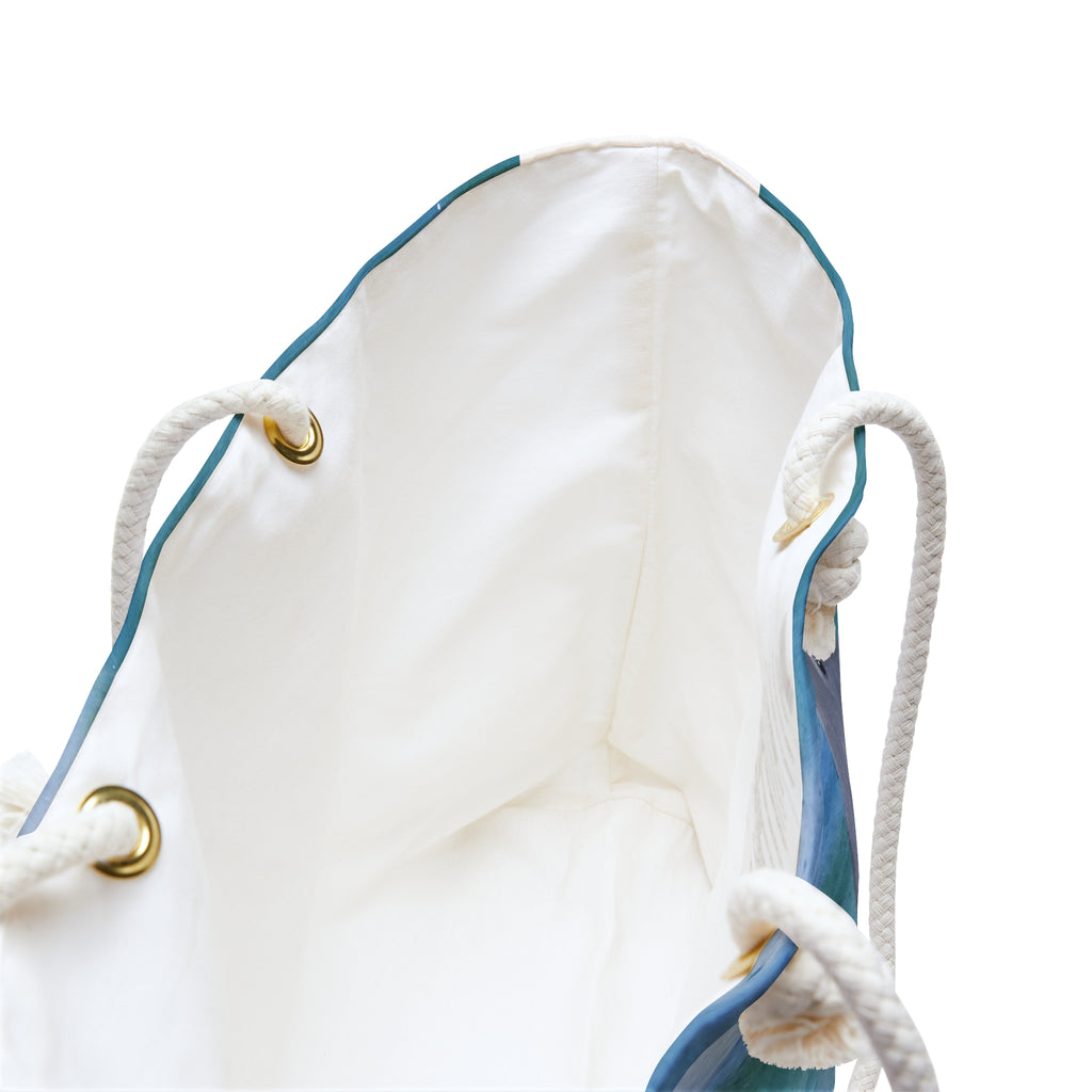 Close-up of a white drawstring bag with blue accents on a white background
