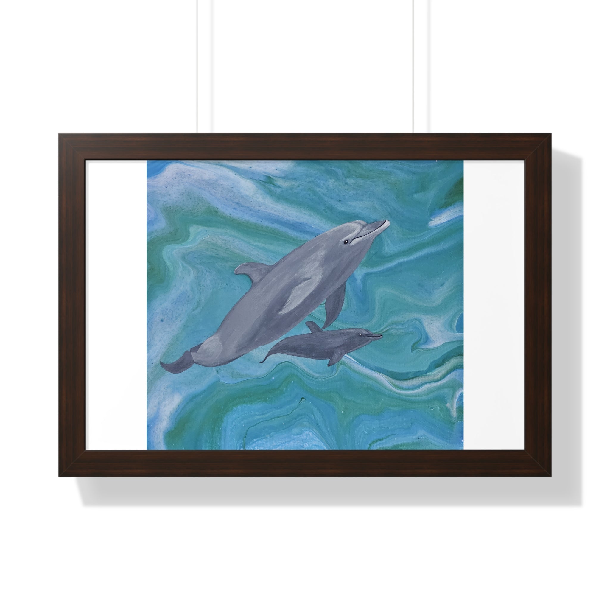 Framed artwork of dolphins swimming in water with a wooden frame.