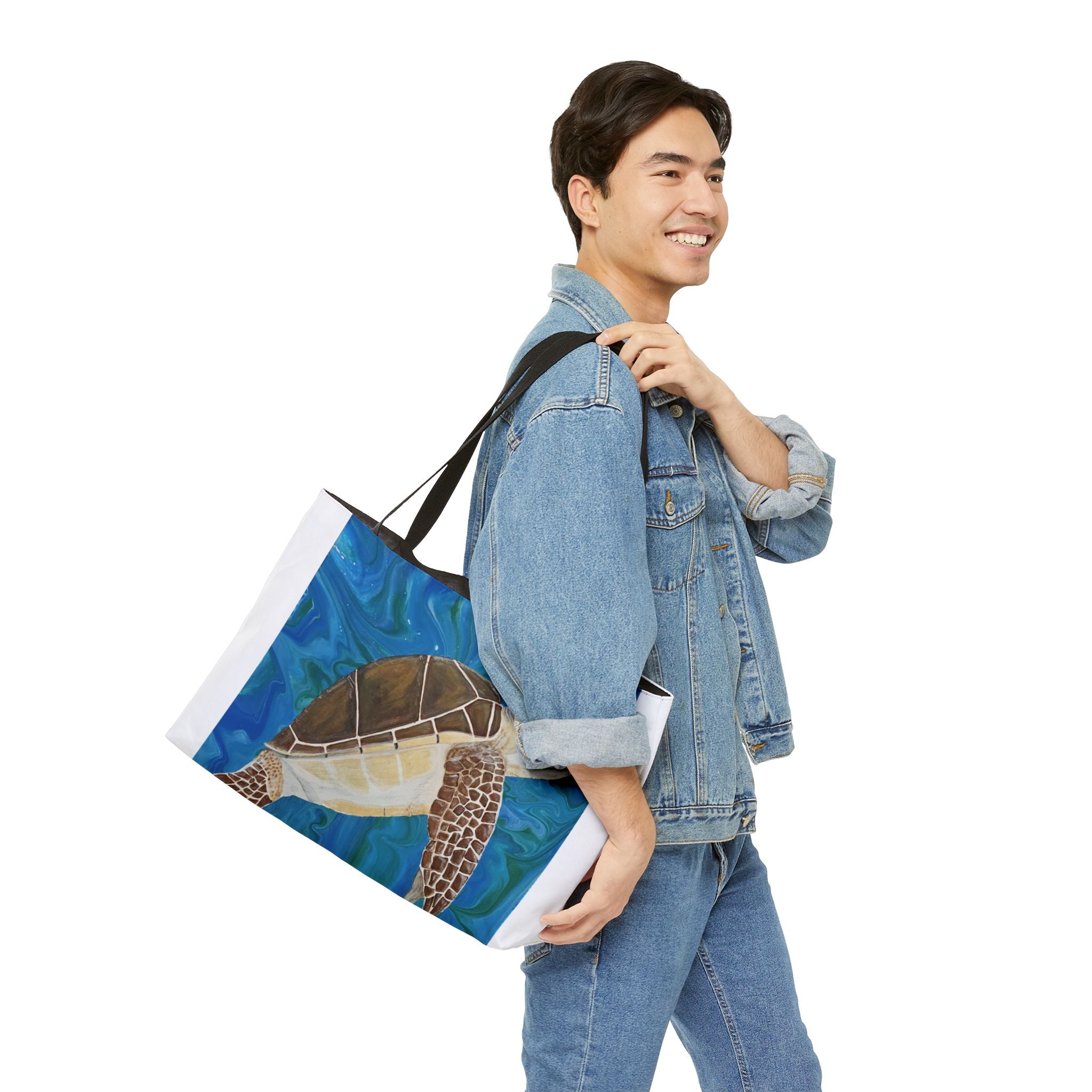 Man carrying a tote bag with a turtle design on a white background