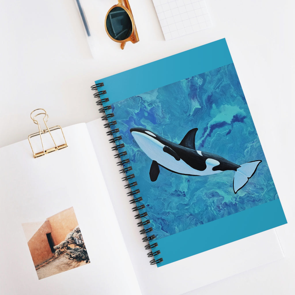 Notebook with an orca whale design on a white surface