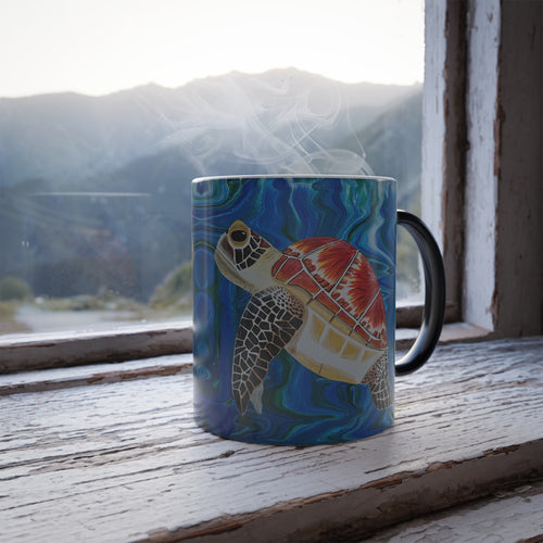 Mug with a turtle design on a windowsill with a mountain view