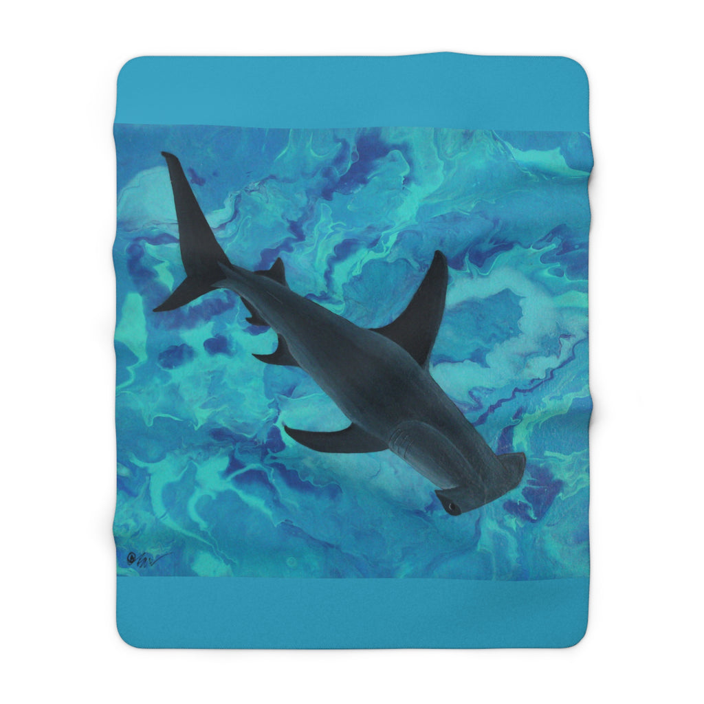 Dolphin design on a blue and green patterned blanket