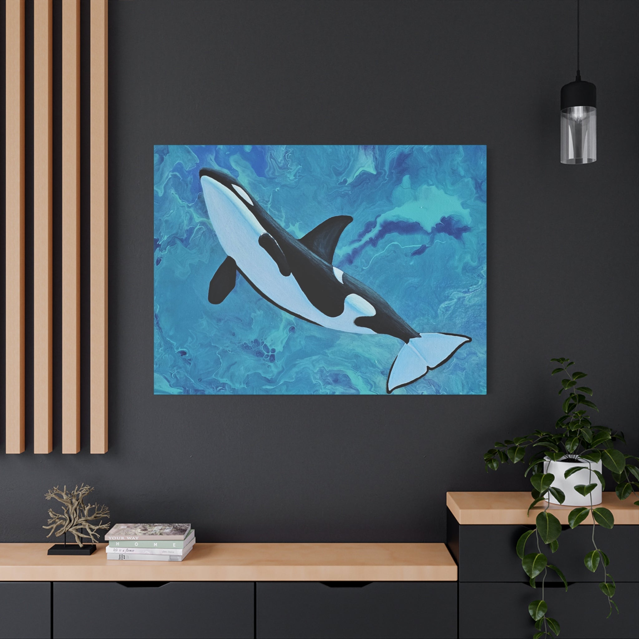 Orca whale painting on a dark wall with wooden shelves and decor.