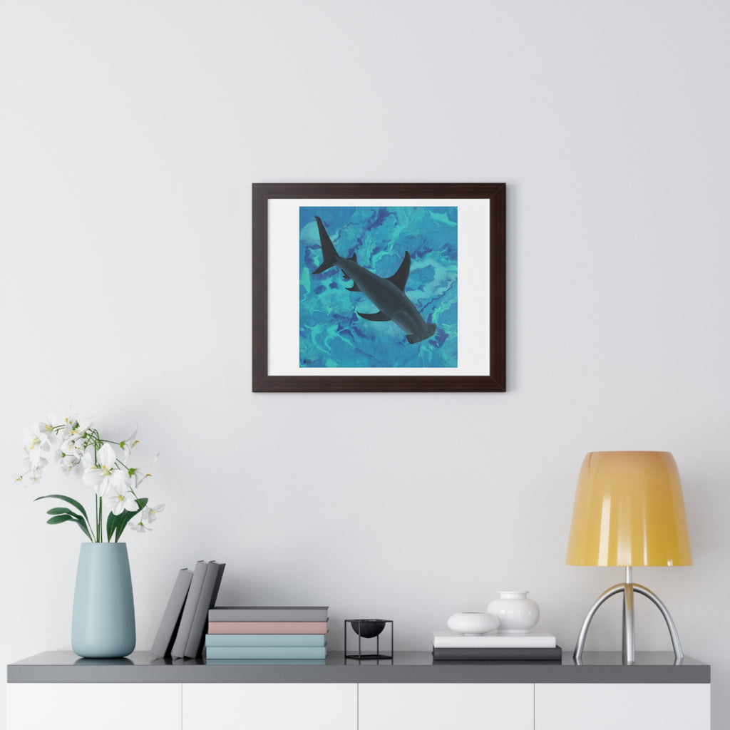 Framed artwork of a shark in water on a wall above a shelf with decor items.