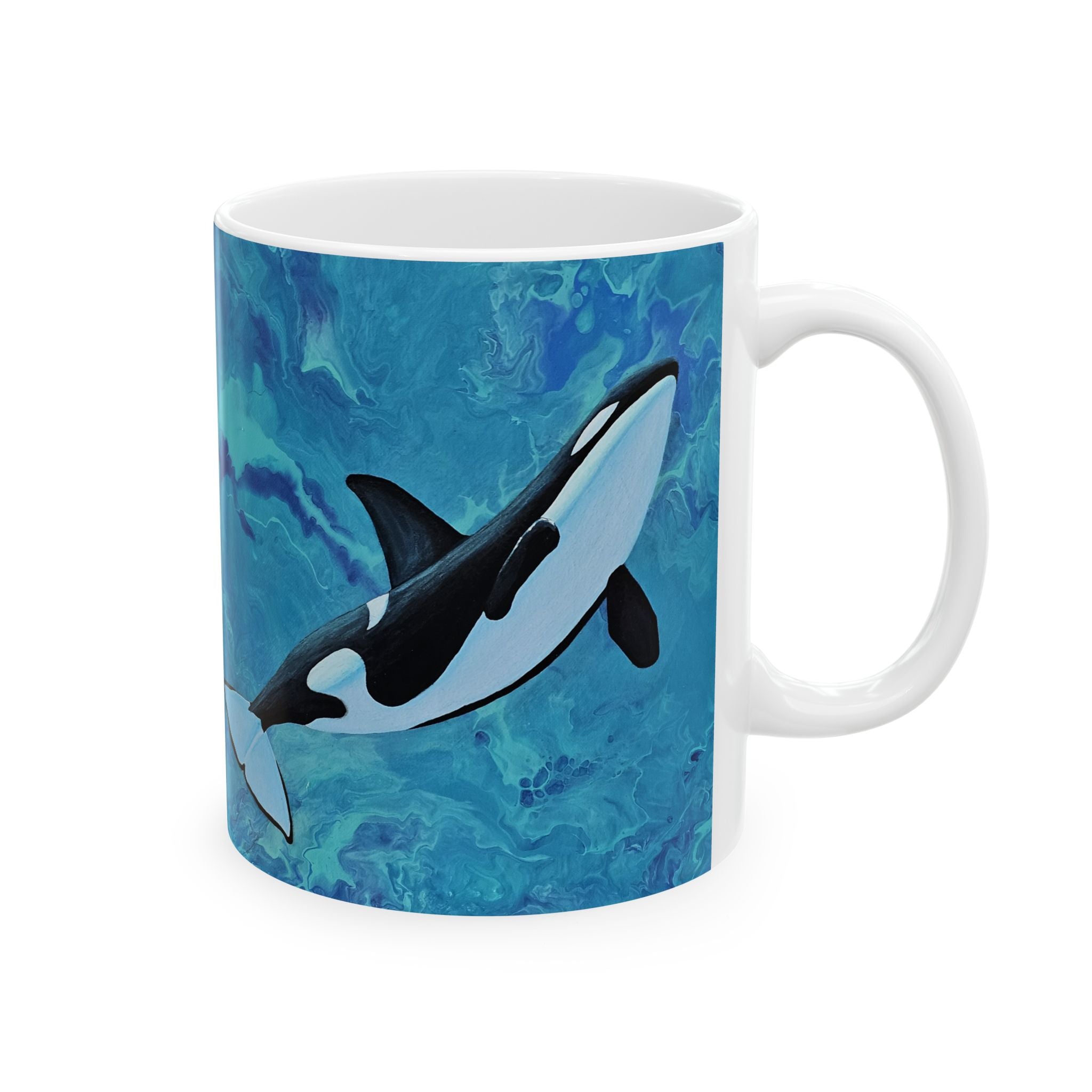 Mug with an orca whale design on a blue marbled background